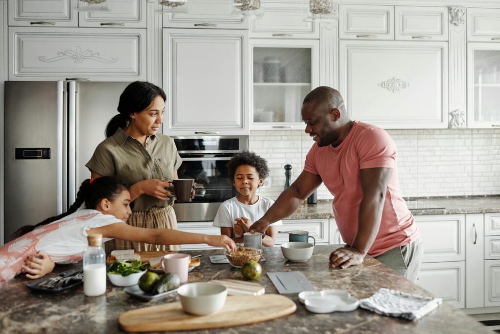 Family at counter in kitchen